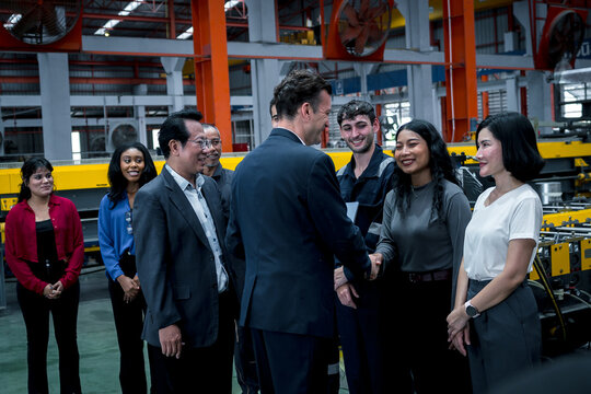 woman worker and engineer under inspection and checking production process on factory station. Factory Engineer. Professional Heavy Industry Engineer Worker. Team of factory workers.