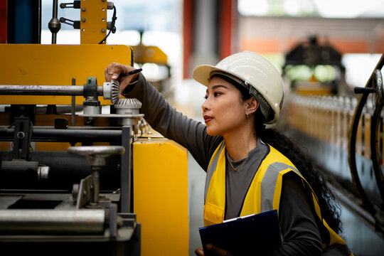 Happy women engineer worker enjoy working in factory industry.