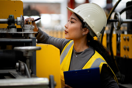 Happy women engineer worker enjoy working in factory industry.