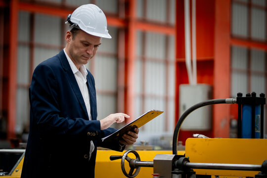 Caucasian professional Engineer factory. Engineering worker in safety hardhat at factory industrial facilities. Heavy Industry Manufacturing Factory