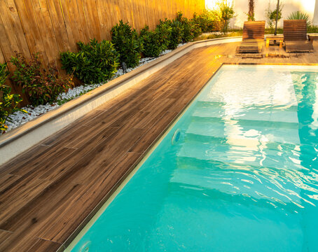 Swimming pool entrance steps with clean blue water at modern villa