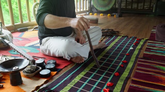 A sound healing lesson using musical notes laid out on a floor rug to simulate musical scales.