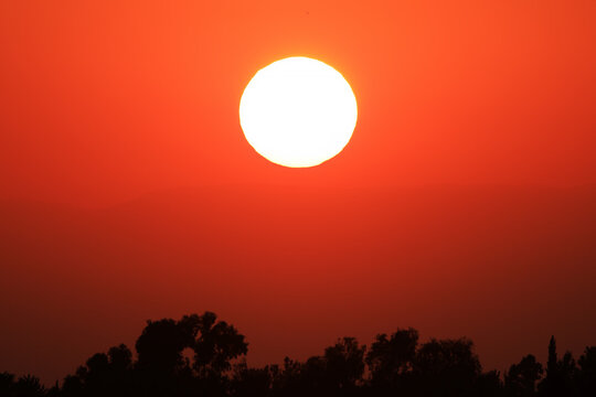 dramatic sunset with sun and red color