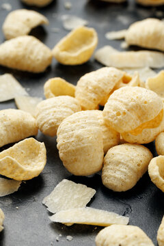 Hummus Chips with Italian Cheese and Black Pepper on dark background