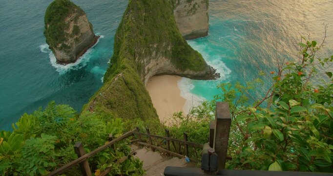 Stairway descent toward iconic Kelingking Beach cliffs on Nusa Penida Bali