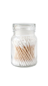 Clear glass jar filled with organic cotton swabs standing neatly isolated on black background