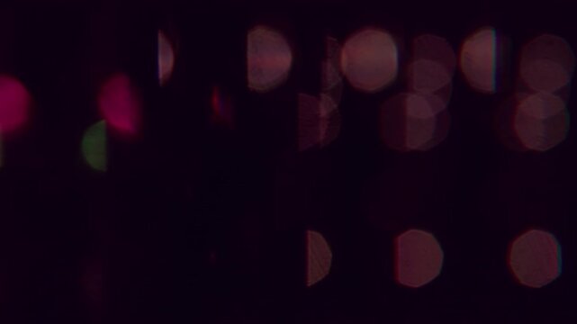 Gleam glow. Blur twinkle. Defocused yellow colorful blaze lens glimmer round shine on abstract bokeh effect dark black art background.