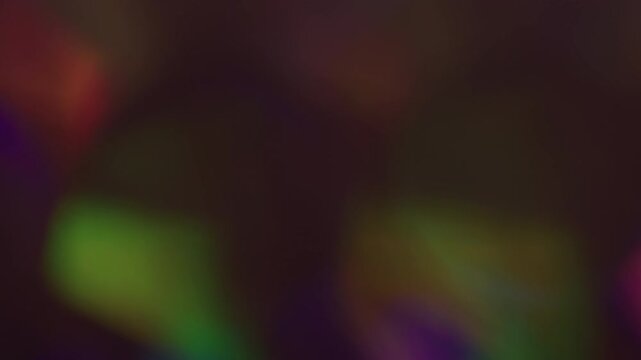 Round reflection. Blur fleck. Defocused blue red green colorful sparkle shine flare flicker gleam glow glare on abstract art dark black background.