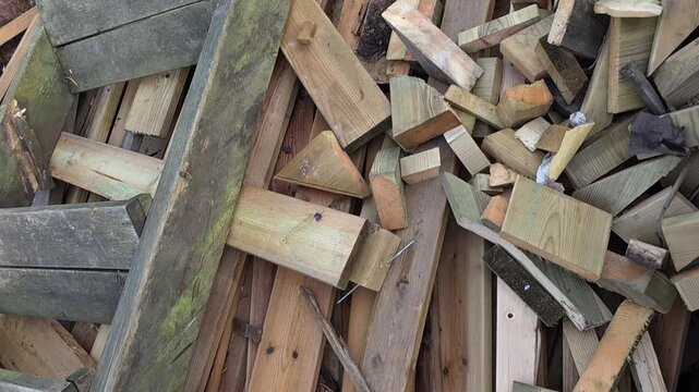 Discarded treated timber and construction wood collected in a waste container for recycling or disposal. Mixed pieces of impregnated wood, boards and offcuts representing construction waste, material 