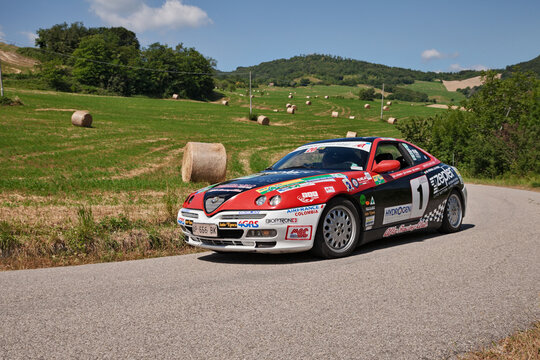 Racing car Alfa Romeo GTV 916C 2.0 V6 TB (1997) traveling on the hills during the classic car rally Colline di Romagna on July 3, 2016 in Tredozio, FC, Italy