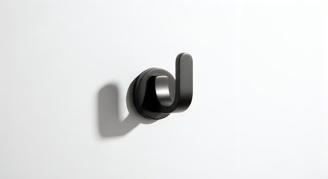 A sleek black hook on a white wall