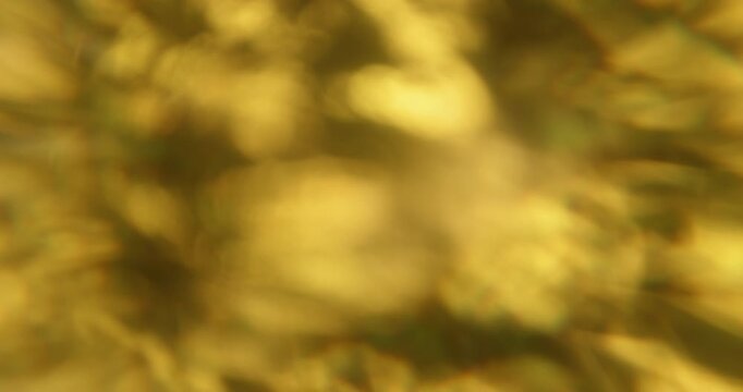 Defocused visual flare. Light leak. Yellow warm blue green colorful rainbow glisten texture optical refraction on abstract bokeh background.