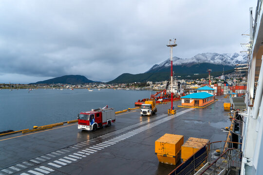 Argentina, the port of Ushuaia, located on the Beagle Canal with the snowy mountains of Tierra del Fuego in the background.
