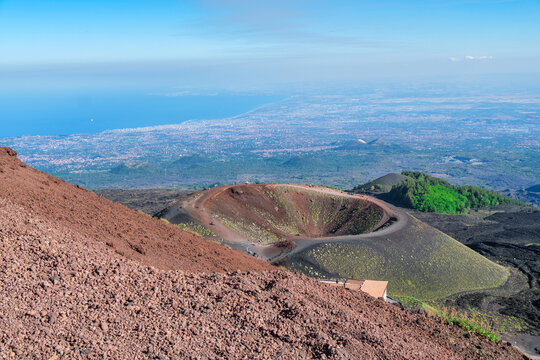 Volcanic cinder cones and craters on Mt Etna with the Gulf of Catania in the distance, Sicily, Italy