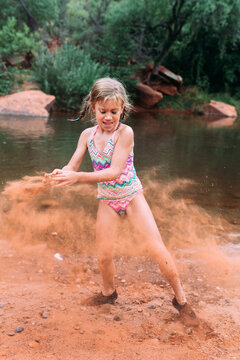 Girl throwing sand on Arizona Beach
