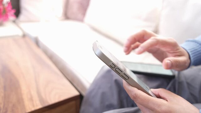 Data Transfer Between Two Smartphones At Home, Middle-Aged Person Completing Device Migration, New Phone Setup, Wireless File Sharing, Cloud Backup, Contact Synchronization And Technology Upgrade.