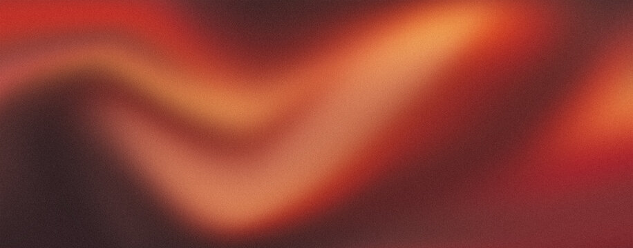 Abstract blurred background with soft grain texture in warm orange and red tones