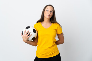 Young football player woman over isolated white background and looking up © luismolinero