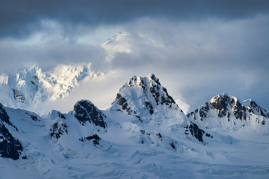 Dramatic mountain landscape covered in snow viewed from Neumayer Channel, Antarctic Peninsula, Antarctica