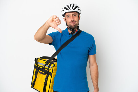 Young caucasian man with thermal backpack isolated on white background showing thumb down with negative expression