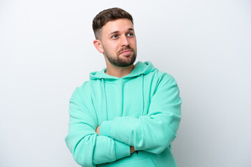 Obraz premium Young caucasian man isolated on white background making doubts gesture while lifting the shoulders