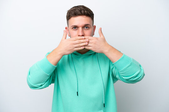 Young caucasian man isolated on white background covering mouth with hands