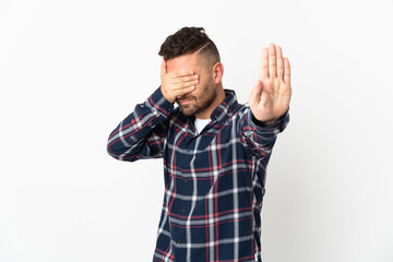 Naklejka premium Caucasian man isolated on white background making stop gesture and covering face