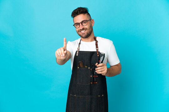 Barber man in an apron showing and lifting a finger