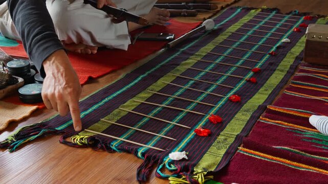 A sound healing lesson using musical notes laid out on a floor rug to simulate musical scales.