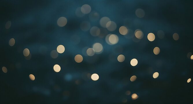 Festive golden bokeh lights glowing softly against a dark blue blurred background with golden glow