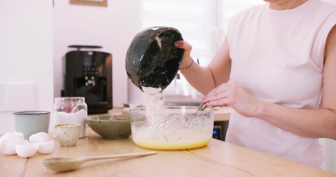 Cooking dough. Pouring flour. Female confectioner hand adding dry baking ingredient to bowl preparing meal tasty recipe at home kitchen.