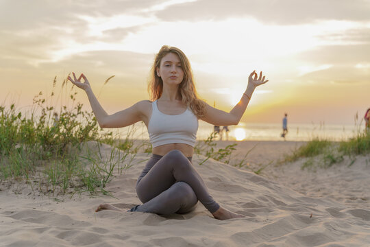 Sunset yoga session on a serene beach with mindful practice and gentle waves