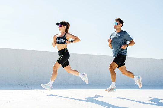 Active runners enjoying a sunny workout on a rooftop during a clear day