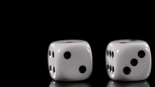 Slow motion of dice rolling and landing with detailed movement and cinematic motion
