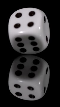 Slow motion of a rolling die showing details of movement and reflection