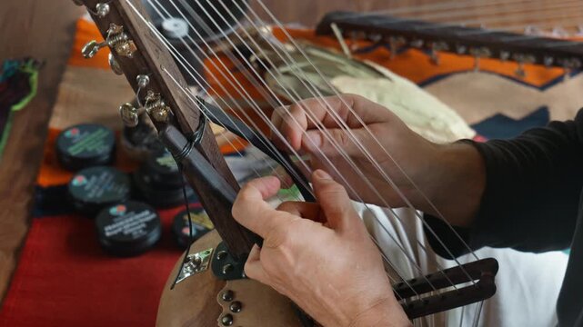 Musician hands playing the harp lyre ethnic musical string instrument