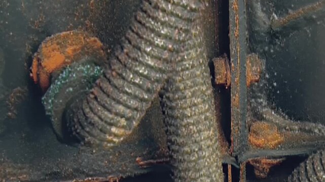 Peering into heart of robust air filter system. Grimy metal, rusted surfaces, and vital hoses showcase demanding life of industrial machinery, ensuring pristine air flow during relentless operations.