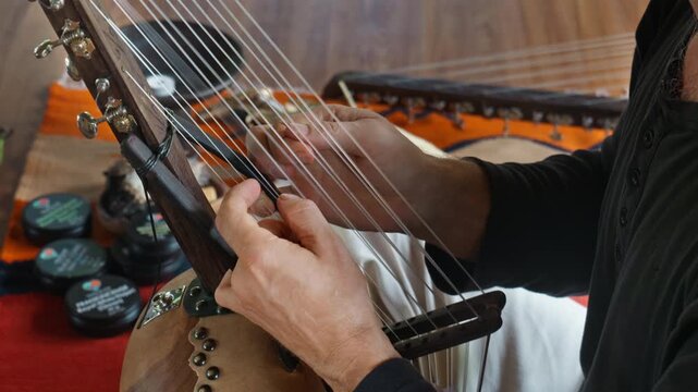 Musician hands playing the harp lyre ethnic musical string instrument