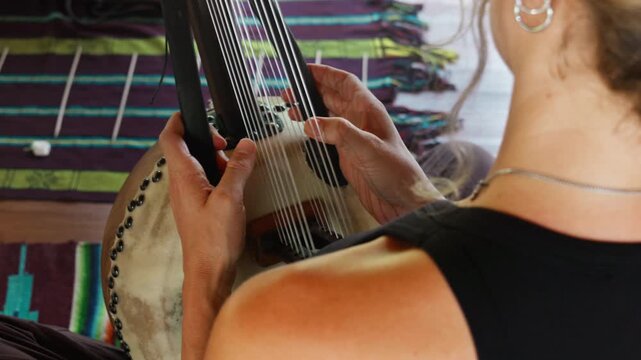 Musician hands playing the harp lyre ethnic musical string instrument