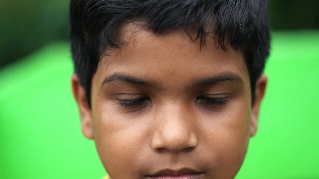 Young Indian Boy Opening And Blinking Eyes Close Up Front View Natural Daylight