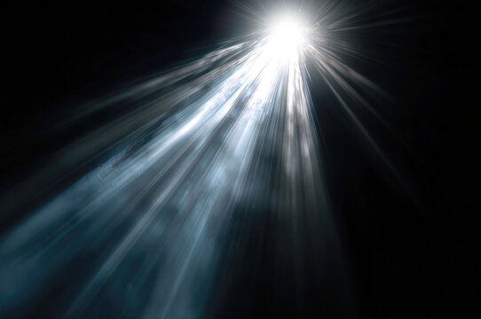 Light technology. Bright white beams radiate through darkness, creating an abstract concept of illumination, energy, hope, discovery and breakthrough.