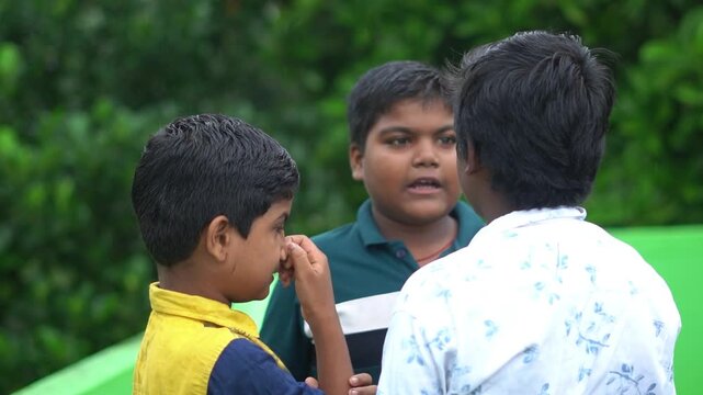 Indian Children Talking And Interacting Together Outdoor Green Background. Friends Standing Outdoors Natural Daylight.