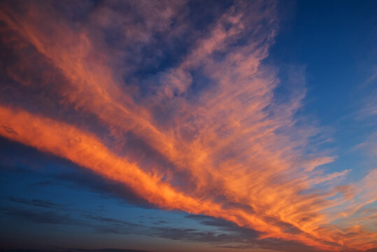 Vibrant Sunset Sky With Dramatic Orange Clouds And Deep Blue Sky