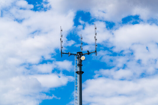 A specialised radio broadcasting communications mast with dipole antennas and parabolic dish