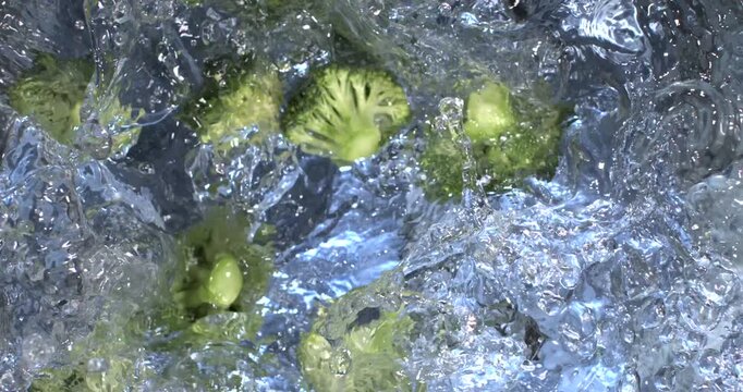 Slow motion of broccoli falling into water with detailed motion analysis