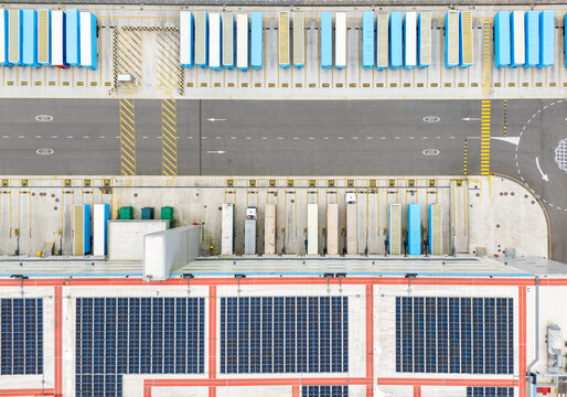 Logistics center with solar panels on roofs. Aerial view