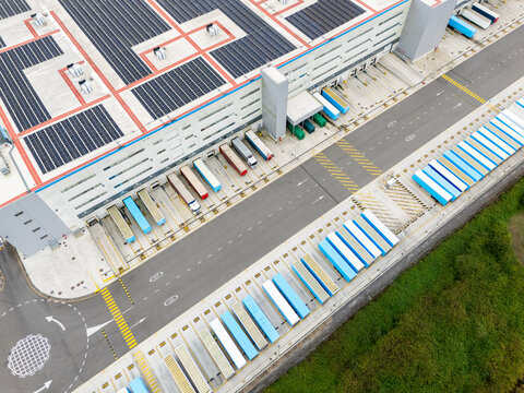 Logistics center with solar panels on roofs. Aerial view