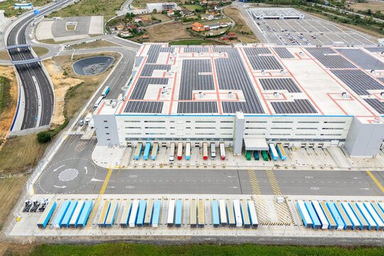 Logistics center with solar panels on roofs. Aerial view