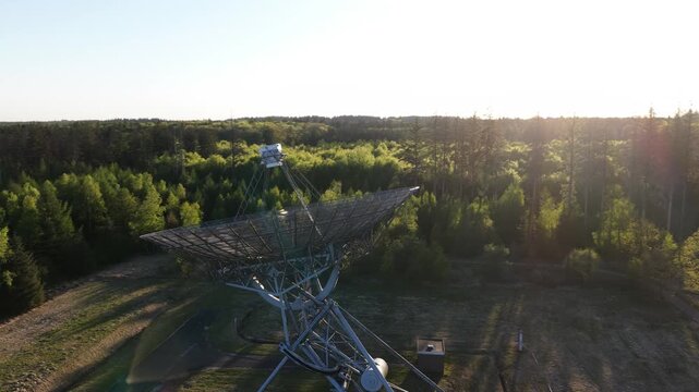Aerial view of radio telescope searching sky at sunset