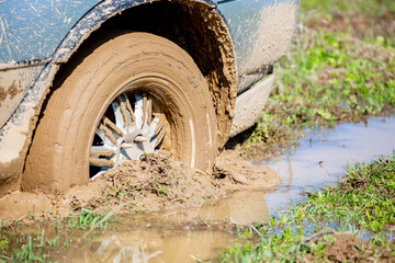 Car wheel stuck in mud, motorsport, mud tire testing. Off-road driving, car breakdown. Emergency evacuation. © Vera